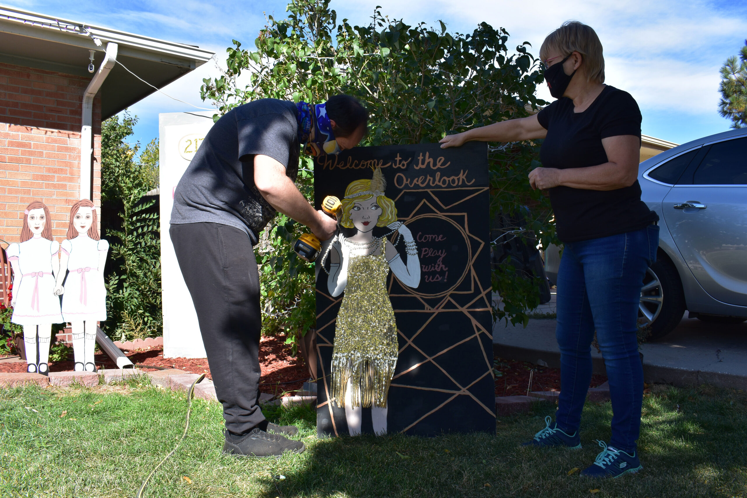 McCawley and Caudill set-up a welcome to the overlook sign in her section of decorations dedicated to "The Shining." McCawley repurposed the sign, which was originally created for her daughter's roaring 20s themed bridal shower. Westminster, Colo., Oct. 12, 2020. (Kerry McCawley/MSU Denver)