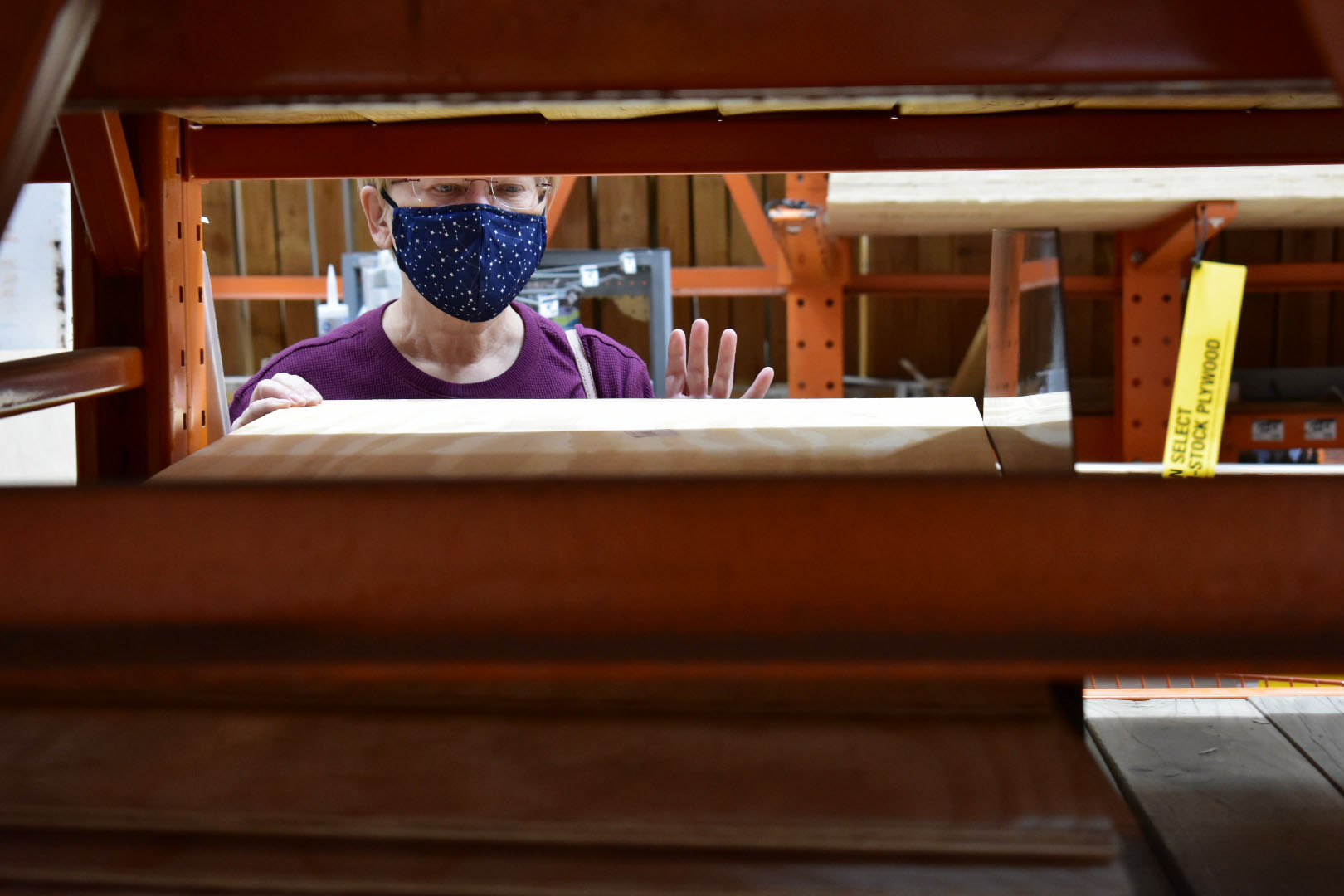 McCawley examines the plywood to find the best one for drawing on. Westminster, Colo., Nov. 13, 2020. (Kerry McCawley/MSU Denver)