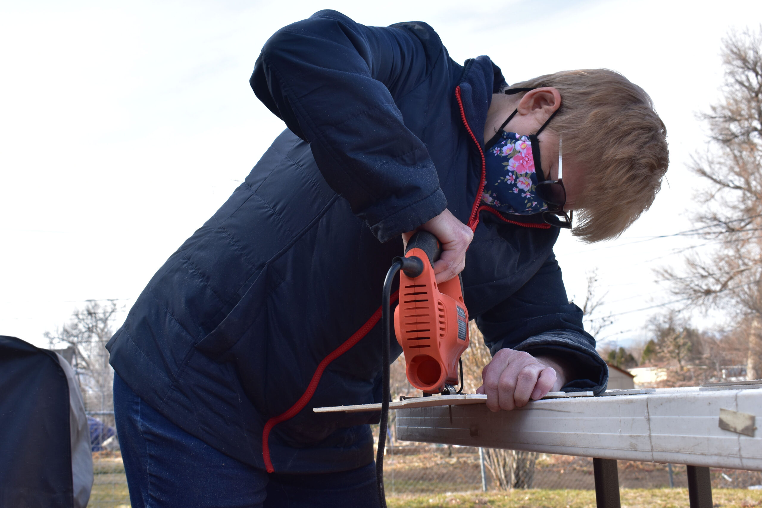 The saw blade breaks through the wood in a buzz that's music to McCawley's ears. McCawley cuts out her drawings of The Peanuts for part of her Christmas display. Westminster, Colo., Nov. 20, 2020. (Kerry McCawley/MSU Denver)